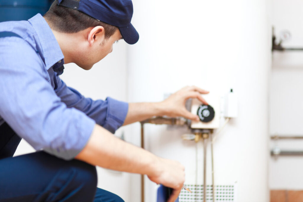 Plumber inspecting a water heater